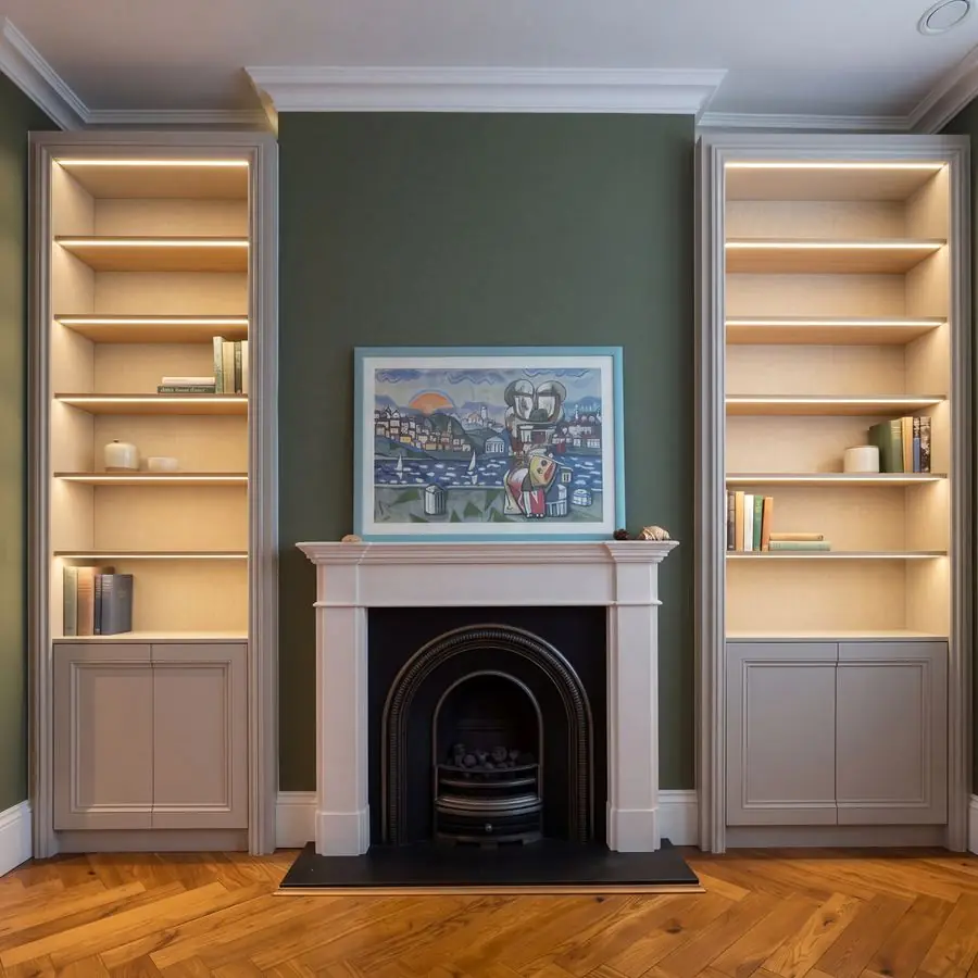 The same shelving with upright lines and even light, the cloth gone and a few books on the shelves.